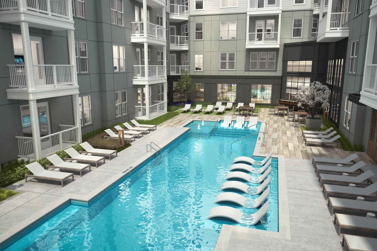 Resort-style swimming pool with sundeck lounge chairs at The Scottie in Nashville, Tennessee 