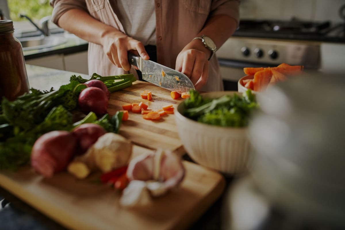 A resident chops fresh vegetables in her kitchen at The Howard, Glendale, California