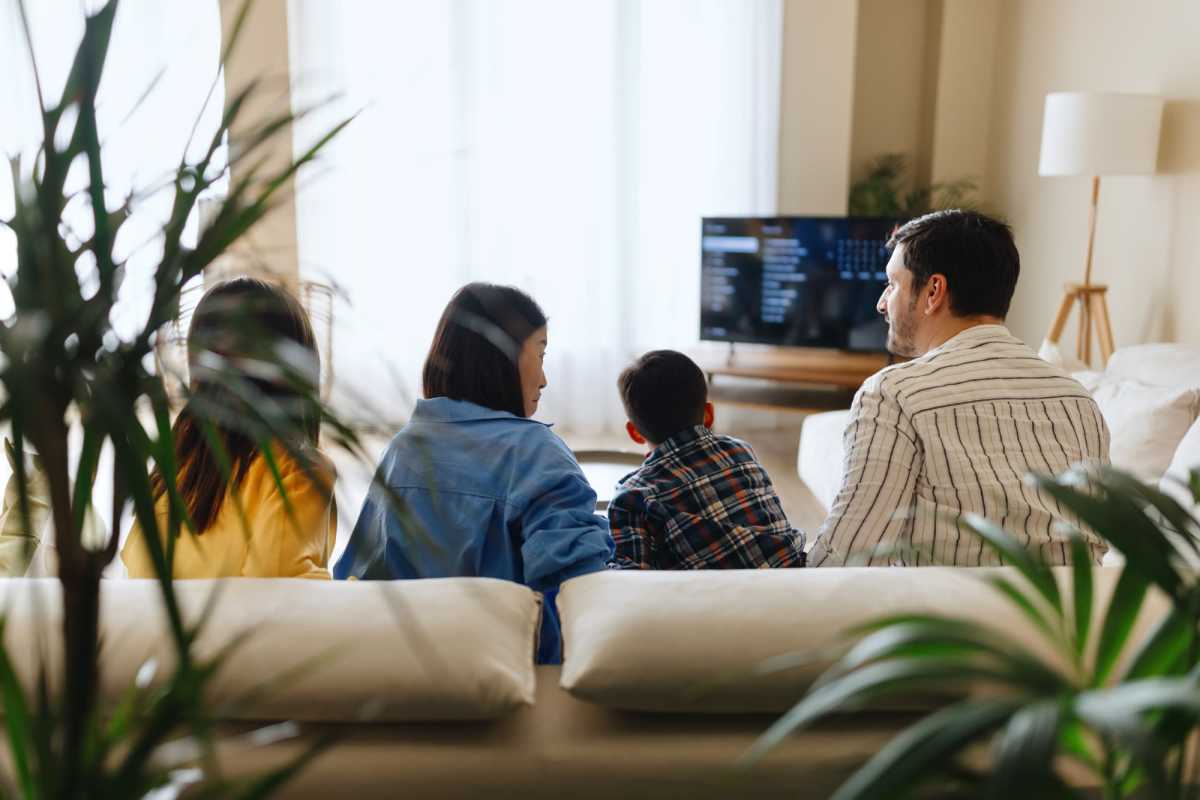 Family sitting on the sofa at Stoney Run Townhomes in Columbia, Maryland 