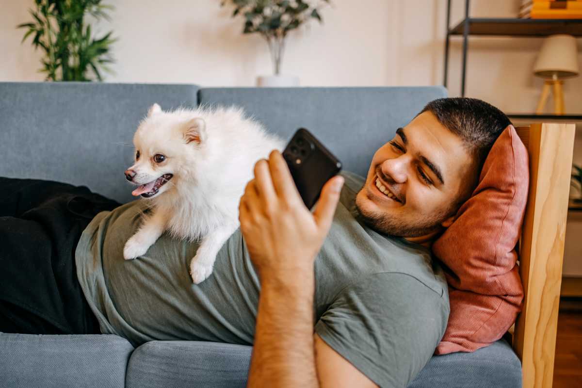 Resident with his pet in living area at Tuscany Court Townhomes in Hondo, Texas  
