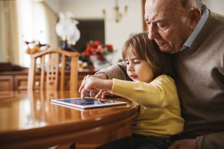 Resident on his tablet at home Watermere Highlands in Arlington, Texas