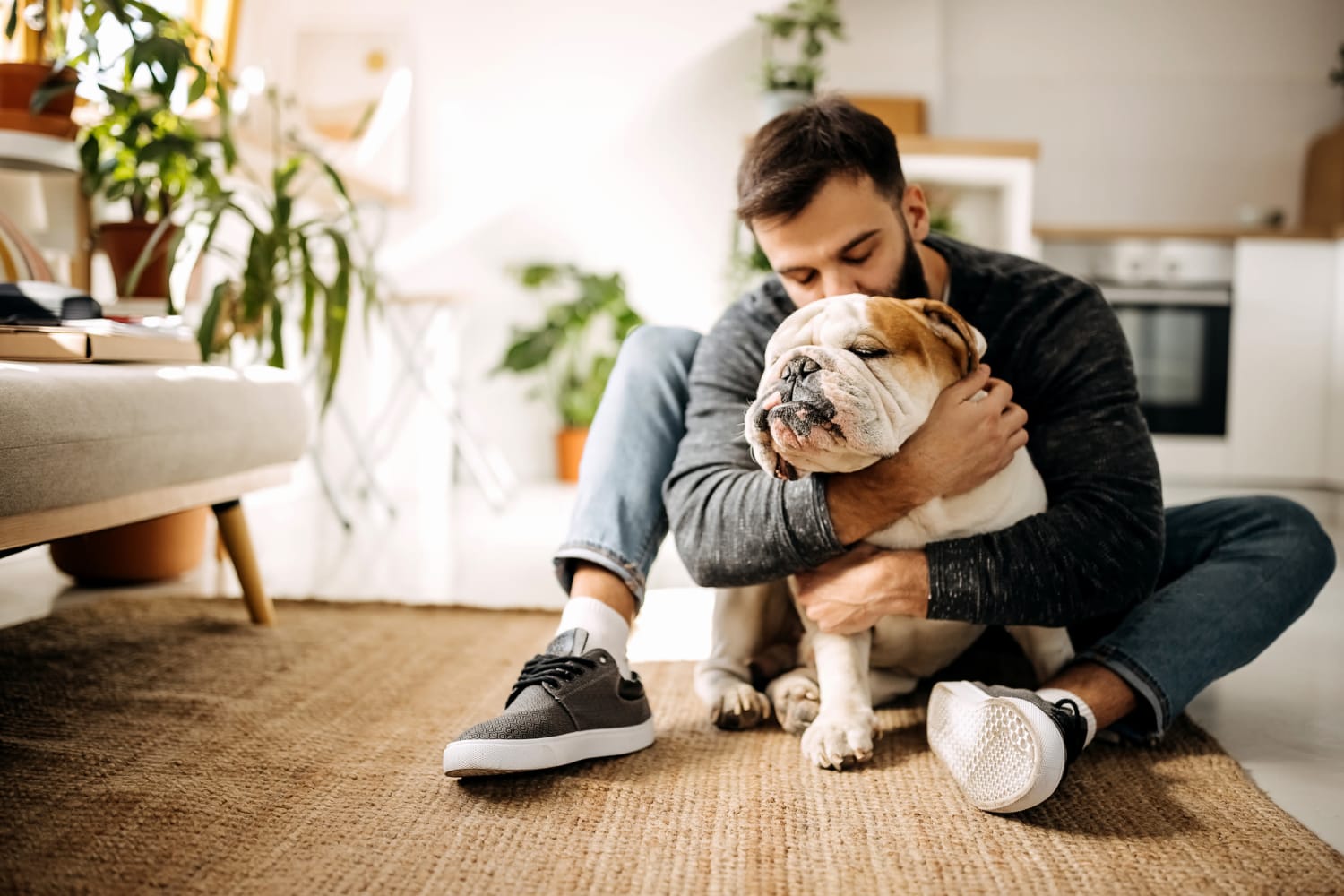 A resident hugging his dog in a pet-friendly apartment at Station 21 Apartments in Mesa, Arizona
