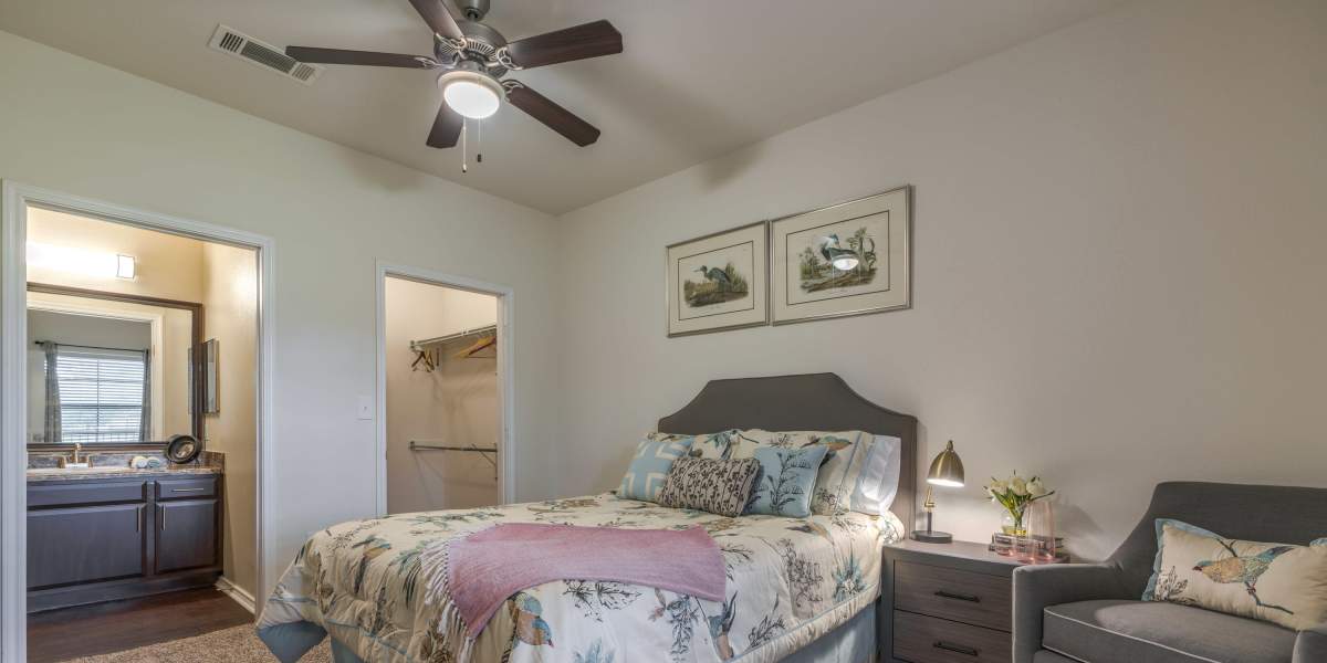 A well-decorated bedroom with comfortable bed and a closet at Edgewater at Klein in Spring, Texas