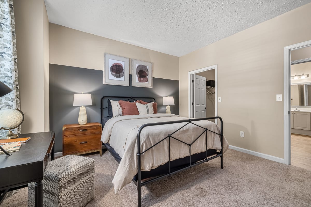 Spacious carpeted bedroom with large window at Marquis at Sugarloaf in Duluth, Georgia