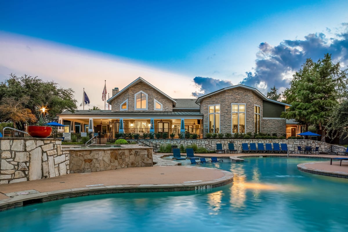 Lit pool beneath purple skies at Marquis on Lakeline in Cedar Park, Texas