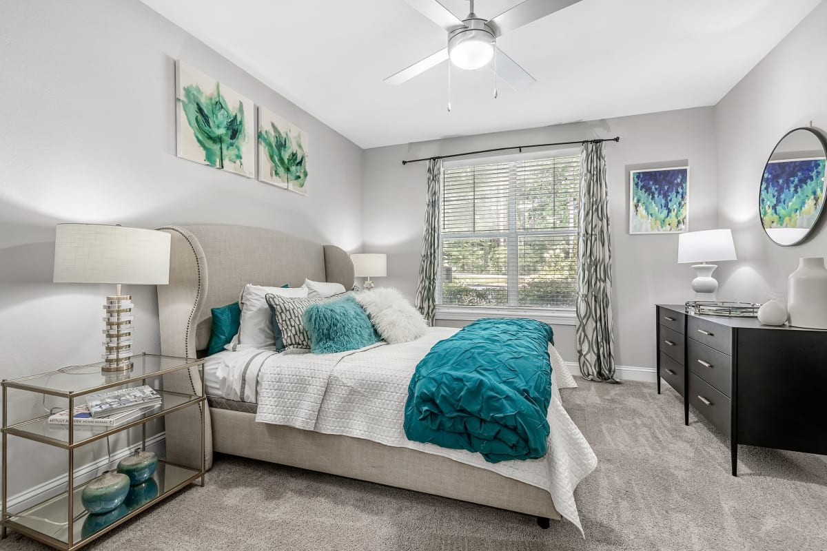 Spacious bedroom with large windows and a ceiling fan at Marq Perimeter in Atlanta, Georgia