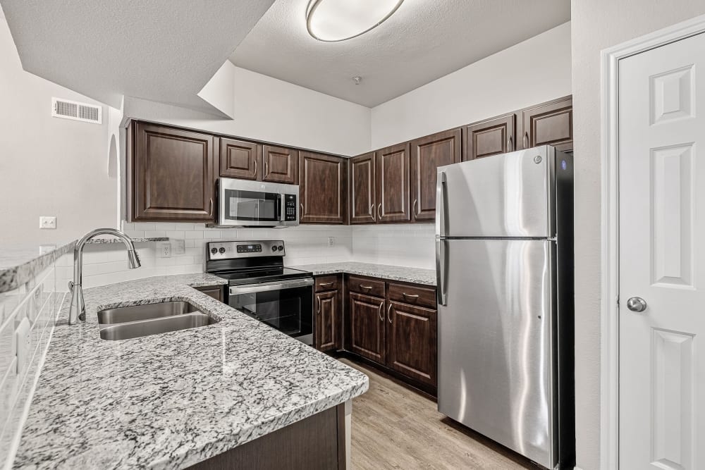 Updated kitchen with granite countertops at Marquis at Stonegate in Fort Worth, Texas