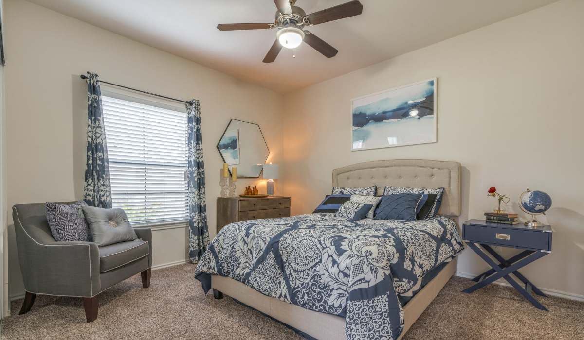Well-furnished modern apartment bedroom with carpet flooring at Edgewater at Klein in Spring, Texas