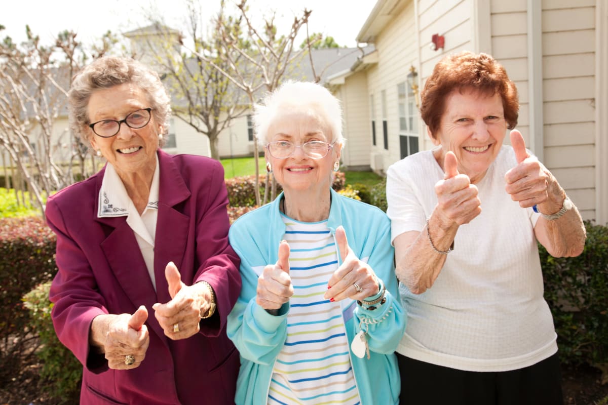 3 Residents Giving the thumbs up outside of Beach House Assisted Living & Memory Care Naples in Naples, Florida