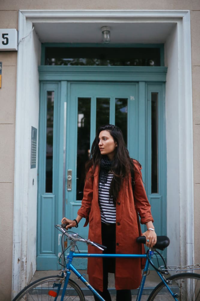 Woman standing with her bicycle about to go for a ride around town near The Main in Evanston, Illinois