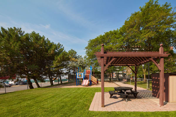 Playground with covered picnic table at Richmond Hill Apartments in Richmond Hill, Ontario