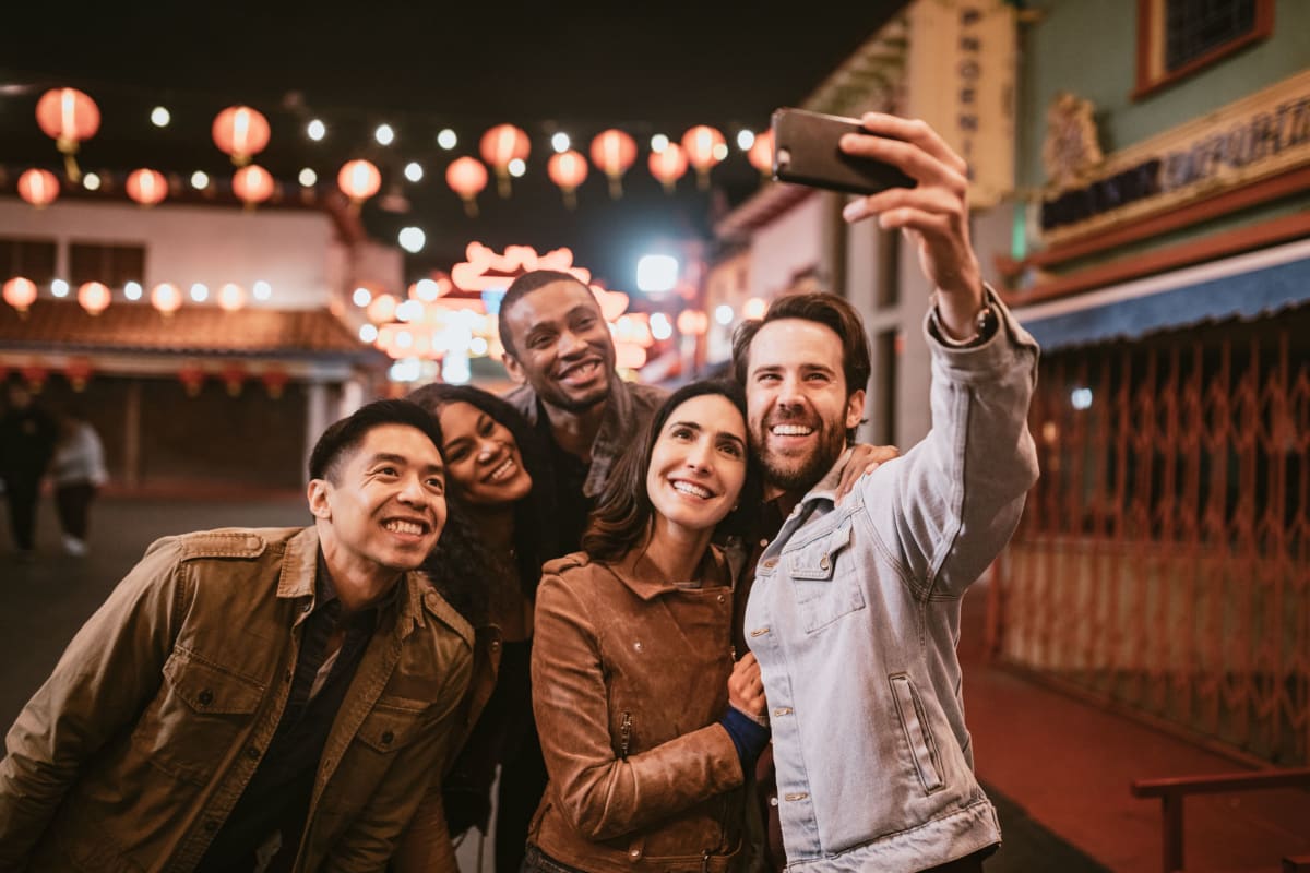 Friends taking a selfie near Windsor Commons Apartments in Baltimore, Maryland