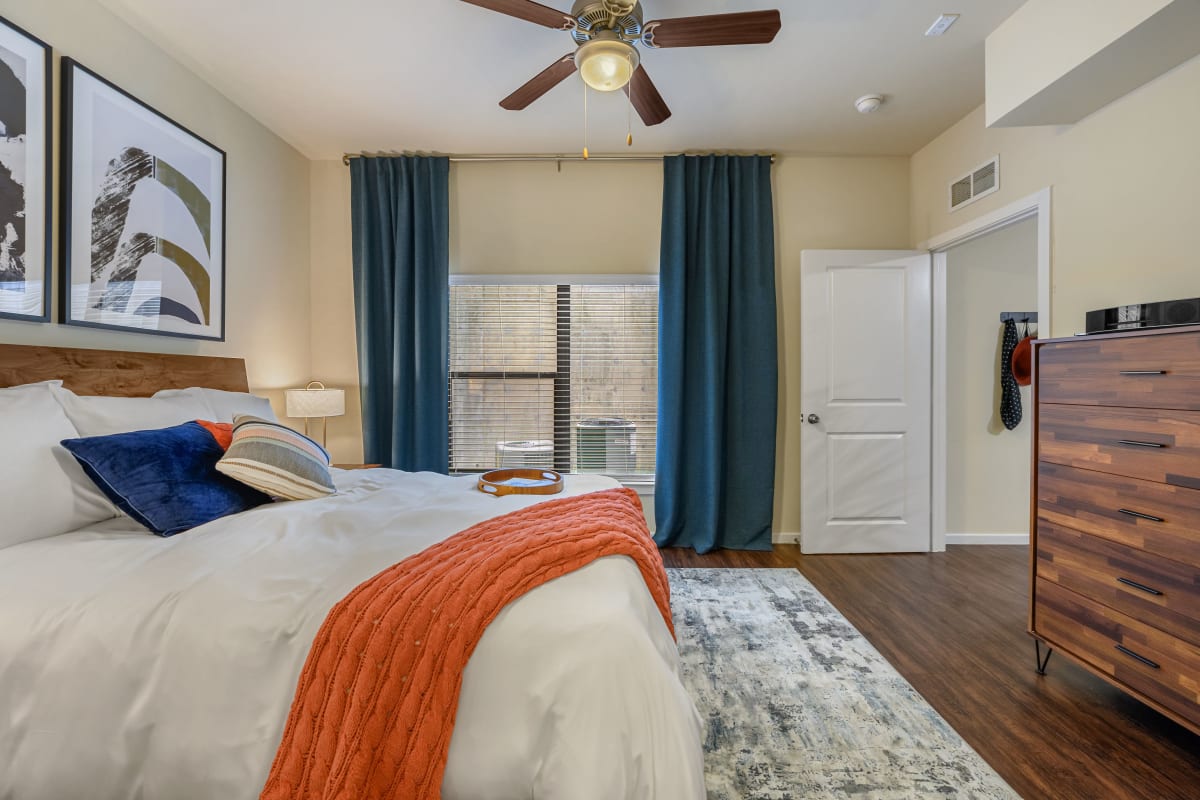 Bright bedroom with wood style flooring at Marquis SoCo in Austin, Texas