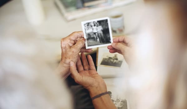 Resident reminiscing over an old photo at Anthology of Stonebridge Ranch in McKinney, Texas