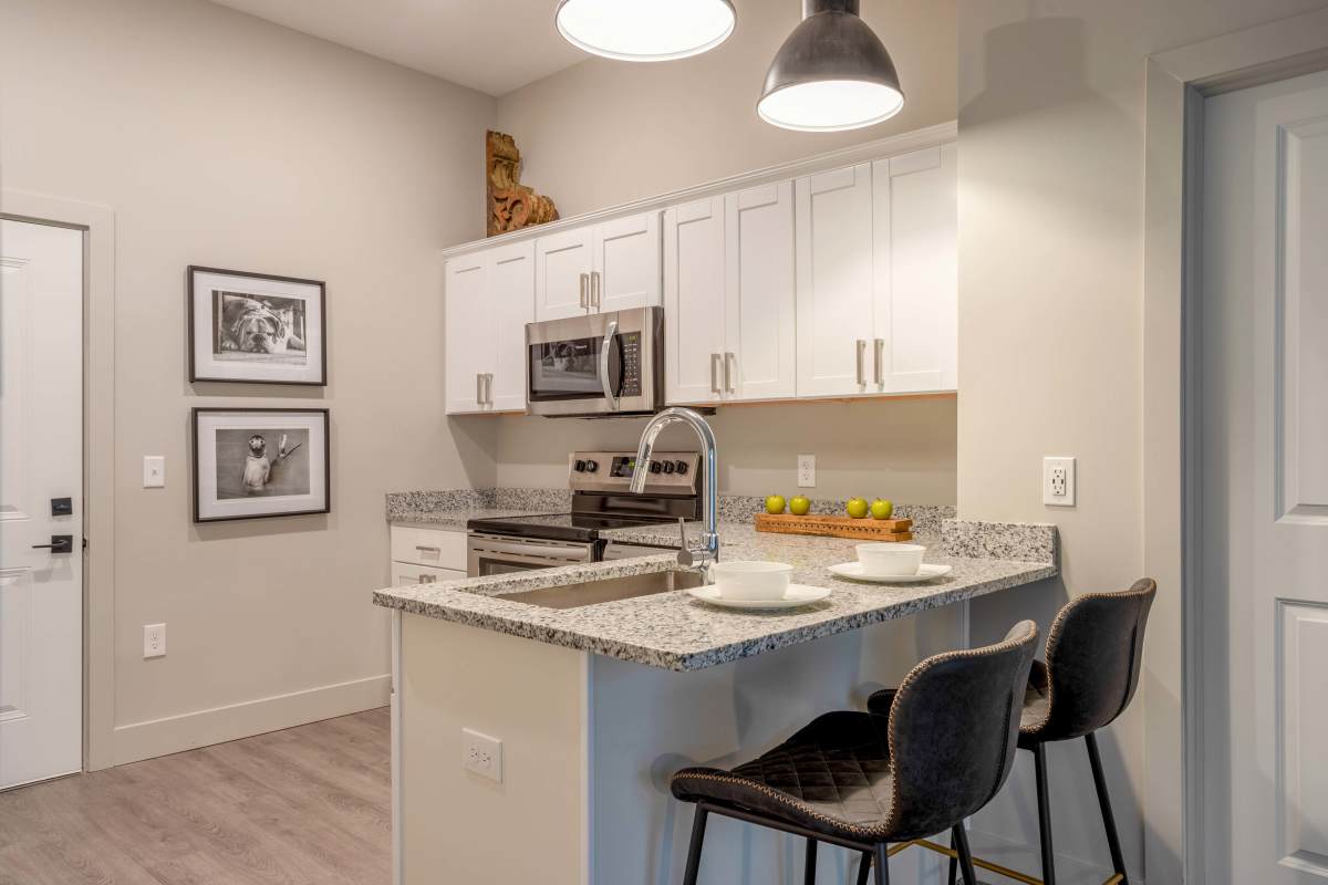 Kitchen with stainless-steel appliances and wooden flooring at Gateway Lofts in Lansing, Michigan