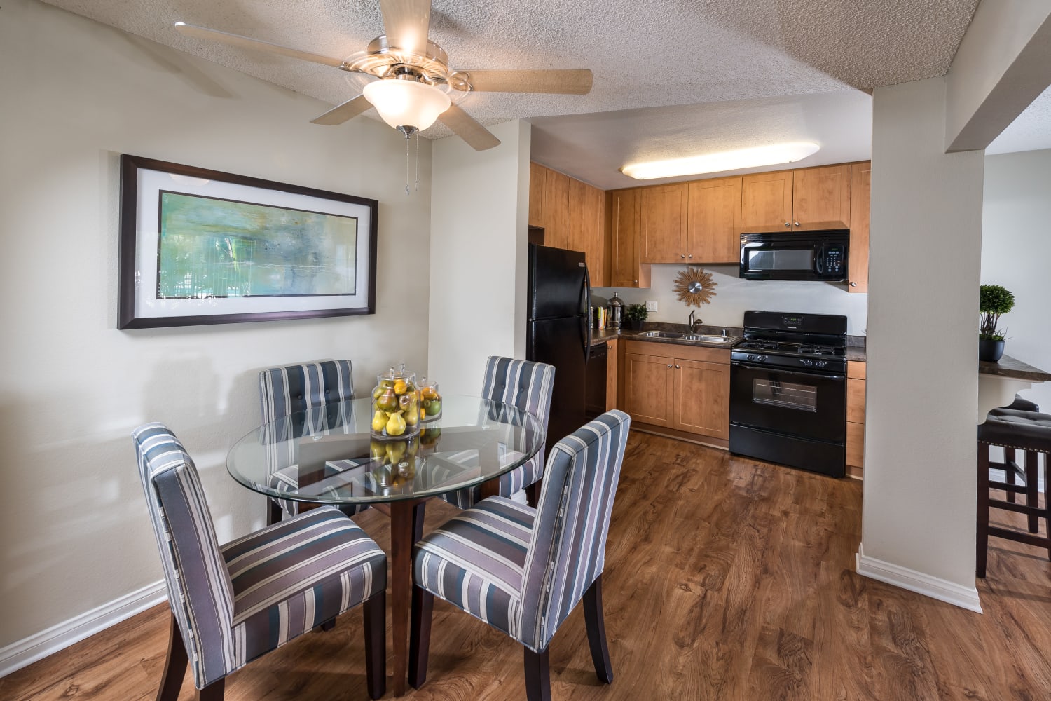 Modern and open dining room and kitchen floor plans at UCE Apartment Homes in Fullerton, California
