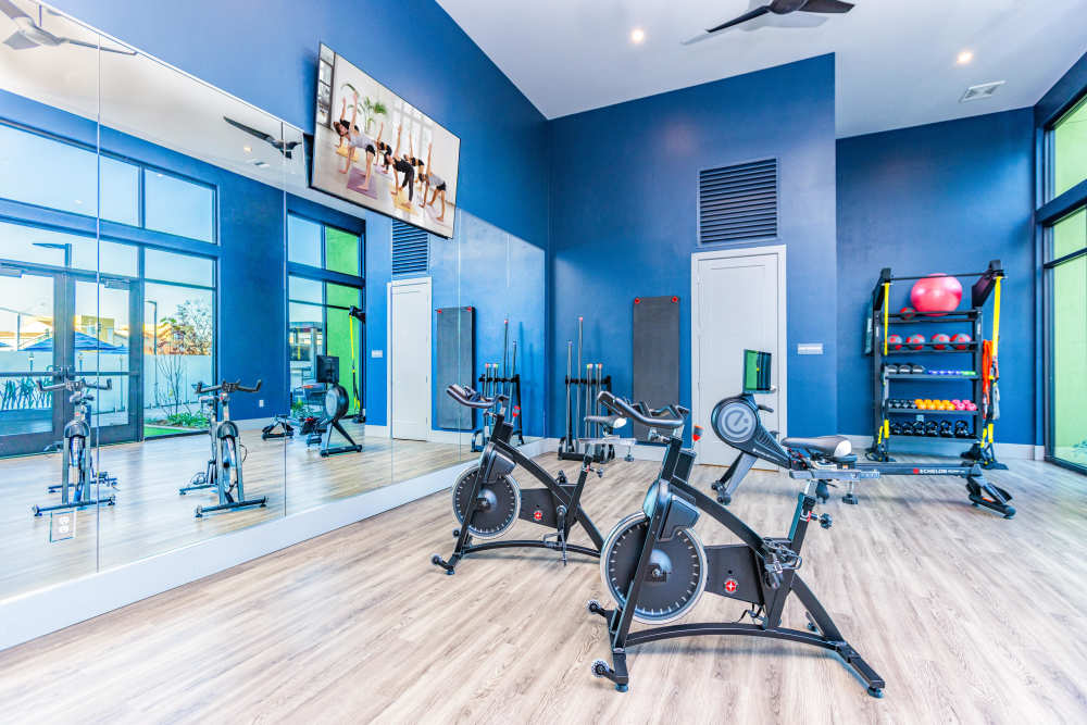 A well-equipped gym room with a range of exercise equipment at Zeta Luxury Apartments, Sacramento, California