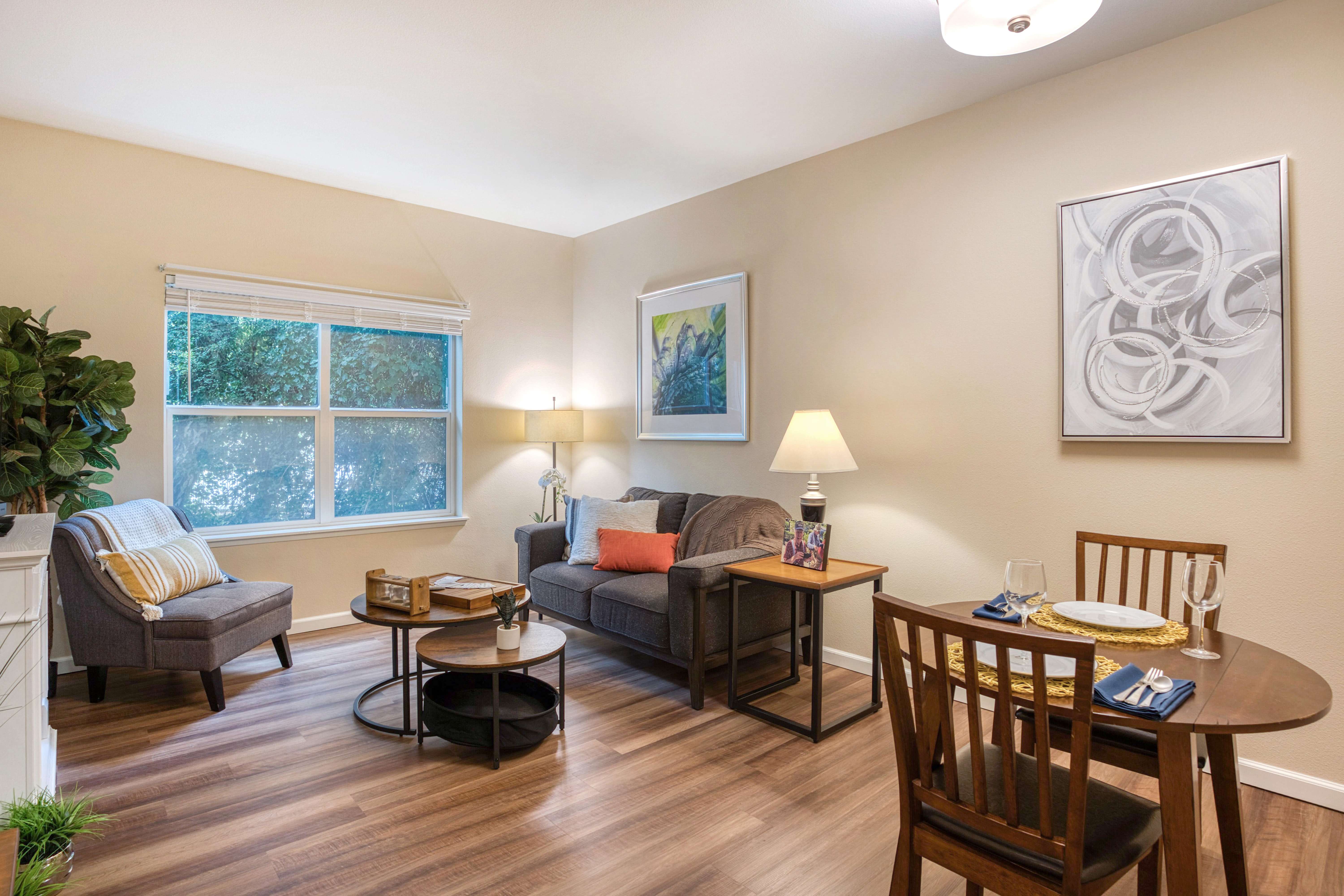 Living room shot with chairs and tables and wooden floor at The Creekside in Woodinville, Washington