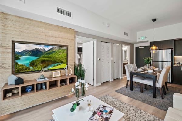 Modern living space leading into kitchen at Oak Enclave in Miami Gardens, Florida