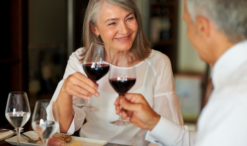 Senior couple reading over menu at The Commons at Dallas Ranch in Antioch, California