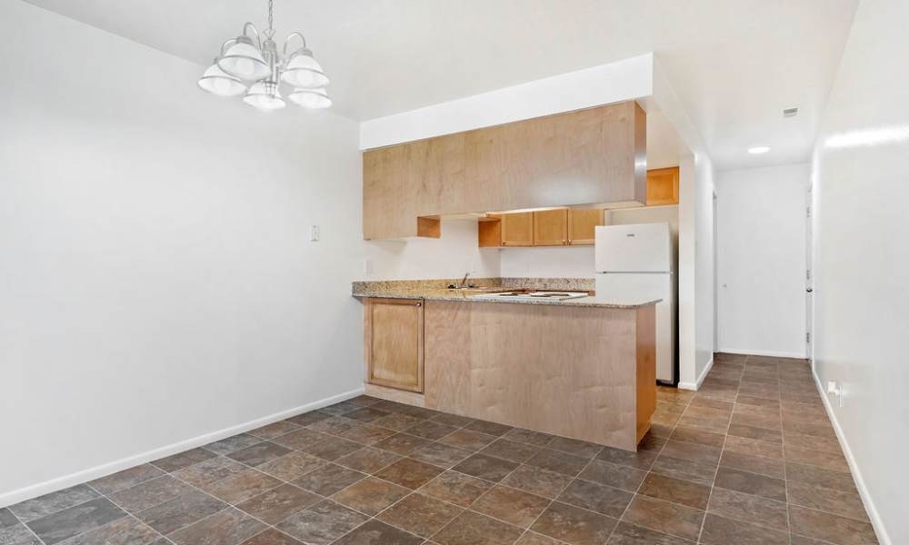 An apartment kitchen with bar seating at Valley Park Apartments in West Valley City, Utah