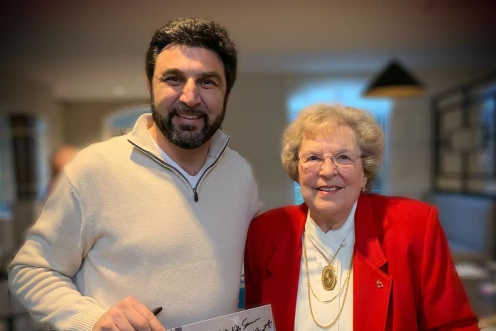 Resident posing for a photo with a guest at Blossom Ridge in Oakland Charter Township, Michigan