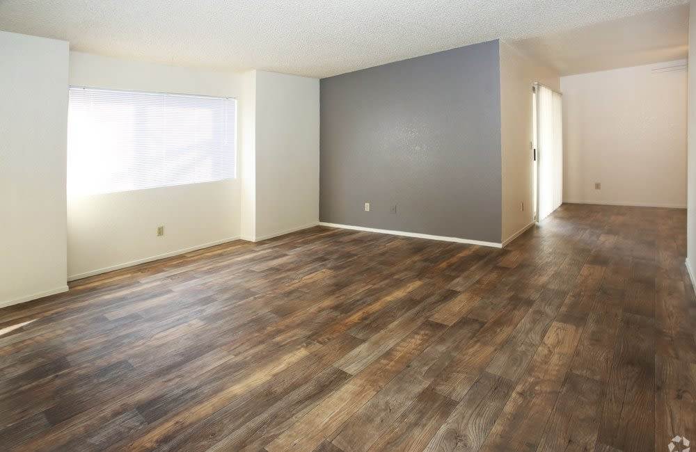 Living room with wood-style floors at  River Terrace in Sacramento, California