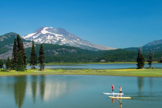 Residents paddle boarding near The Alexander in Bend, Oregon