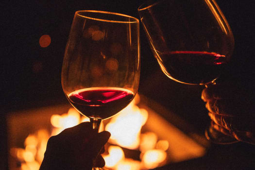 Residents drinking wine beside a fire pit near The Alexander in Bend, Oregon