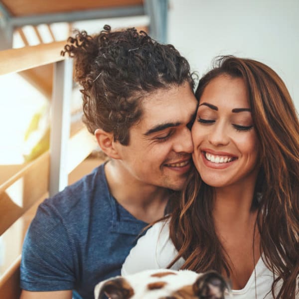 Happy couple playing outside Foundry Townhomes in Simpsonville, South Carolina