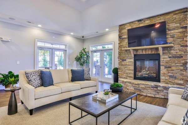 Community clubhouse with wall-mounted TV and fire pit at Arbors at Fort Mill in Fort Mill, South Carolina