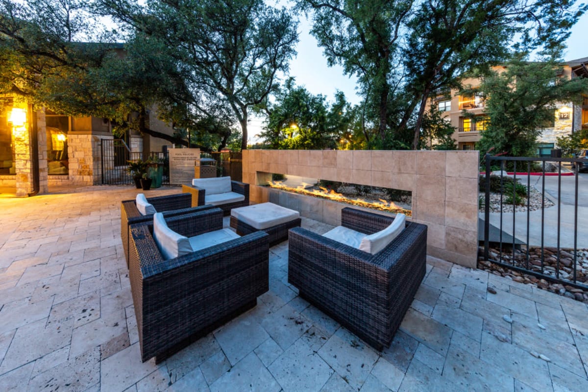 Outdoor lounge with enclosed fire pit at Marquis at Barton Trails in Austin, Texas