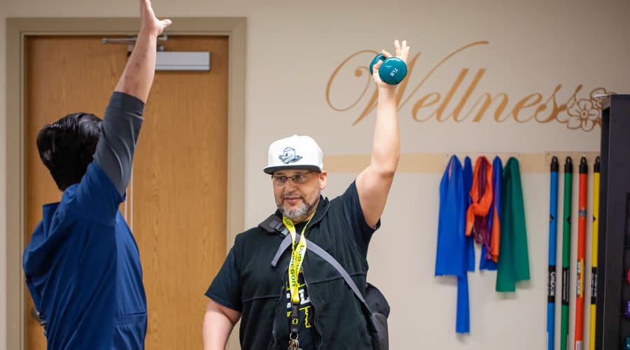 Resident exercising with caretaker at Cascade Park Adult Day Health in Tacoma, Washington