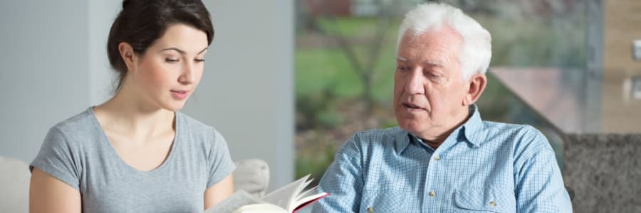 Resident being read to outside in the fresh air at Edgerton Care Center in Edgerton, Wisconsin