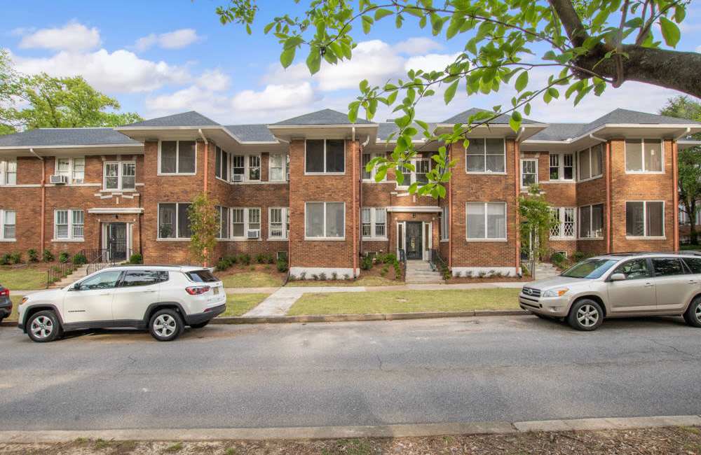 Apartment view from other side of road with cars parked at Belvedere Place in Memphis, Tennessee
