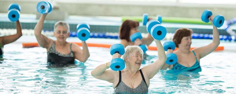 Residents engaged in a group swimming exercise at The Springs at Lake Oswego in Lake Oswego, Oregon