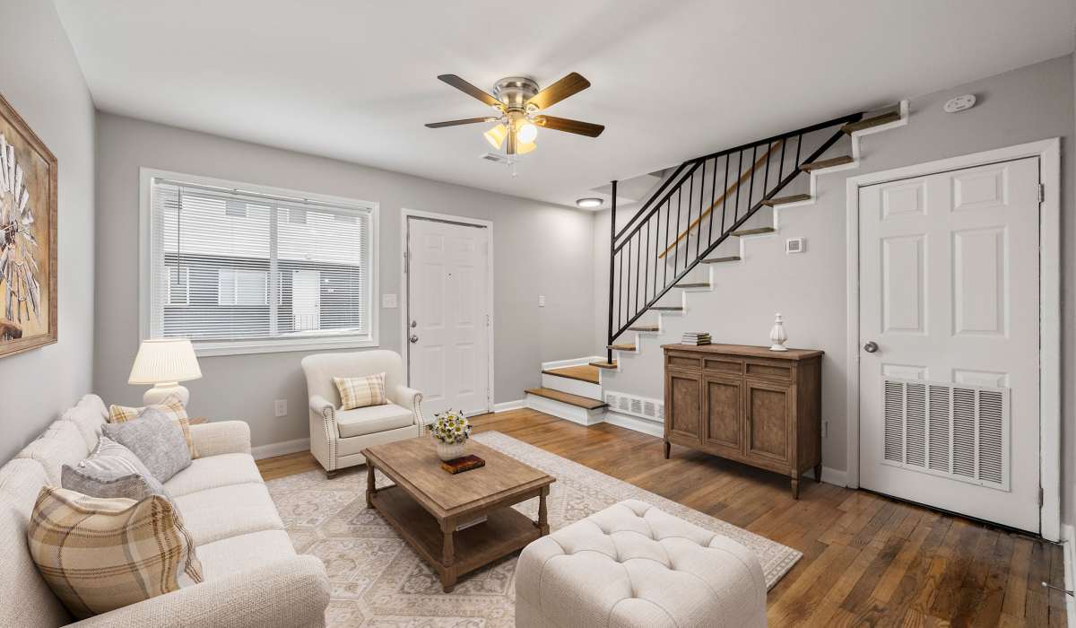 Living room with stair and hard wood flooring at Balfour Chastain in Sandy Springs, Georgia