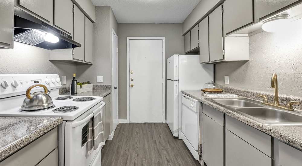Kitchen with white appliances at The Ivy in College Station, Texas