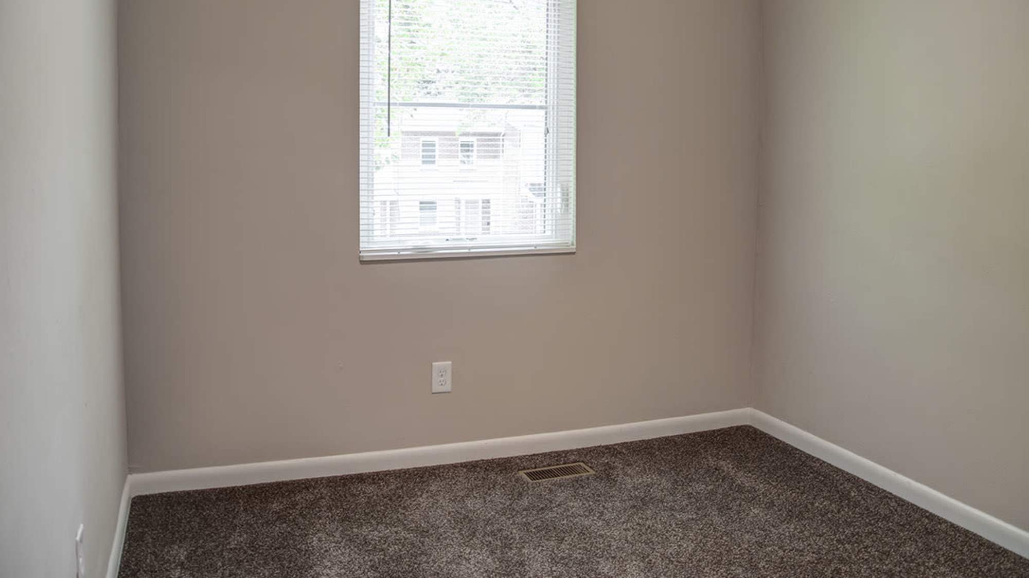 Well-lit apartment bedroom at Bell Diamond Manor in Norfolk, Virginia
