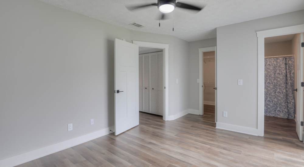 Unfurnished bedroom with attached bathroom at Village Lake Townhomes in Smyrna, Tennessee