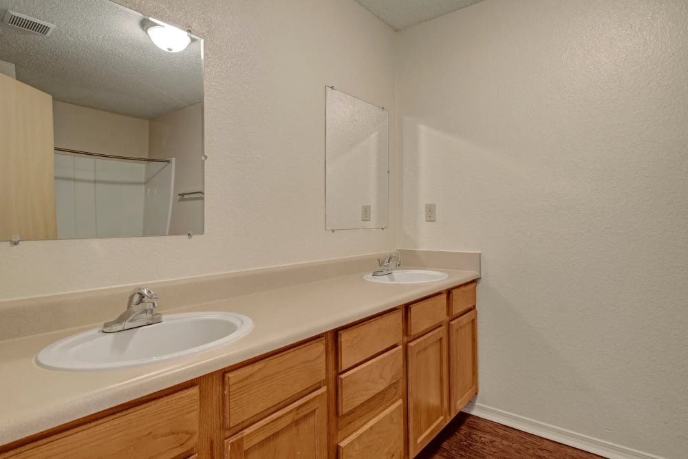 Bathroom with double storage vanity at Yukon on 15th in Yukon, Oklahoma