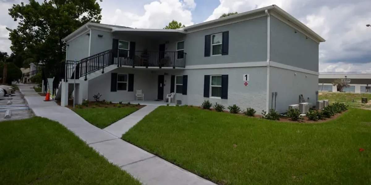 Exterior of apartment with pathway at Wayne Densch Center in Orlando, Florida