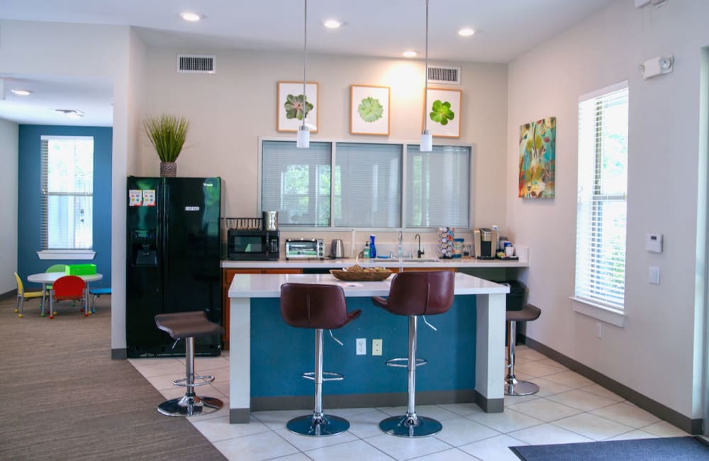 Clubhouse kitchen with bar stool at Cardinal Point in Austin, Texas