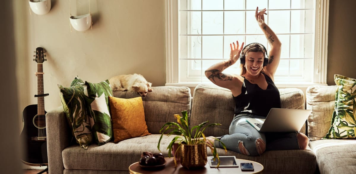 A resident listens to music with headphones in her apartment at Attain at Bradford Creek, Huntsville, Alabama