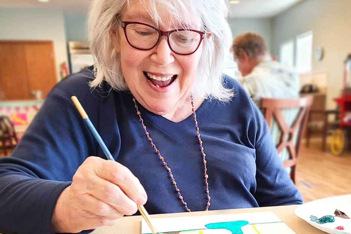 A resident painting at The Oxford Grand Assisted Living & Memory Care in McKinney, Texas