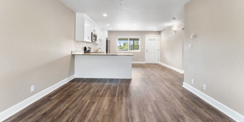 Hardwood flooring in living room and kitchen at Fremont Arms Apartments in Fremont, California