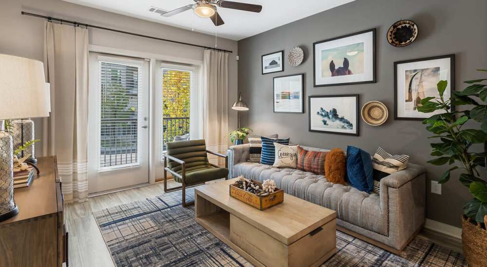 Modern living room with balcony access at The Reid in Tucker, Georgia 