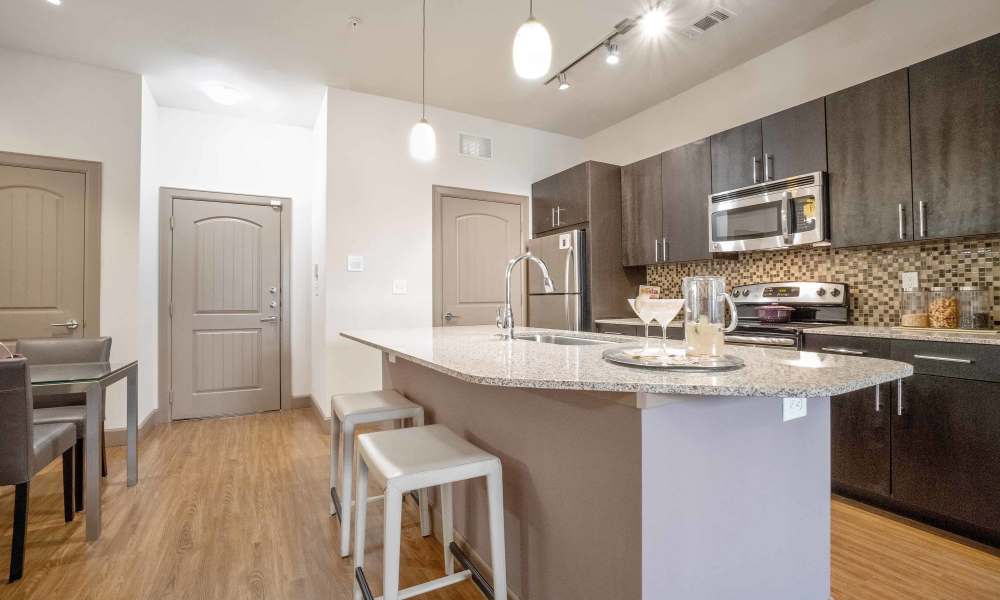 Apartment kitchen with a breakfast island at Grapevine Station in Grapevine,Texas