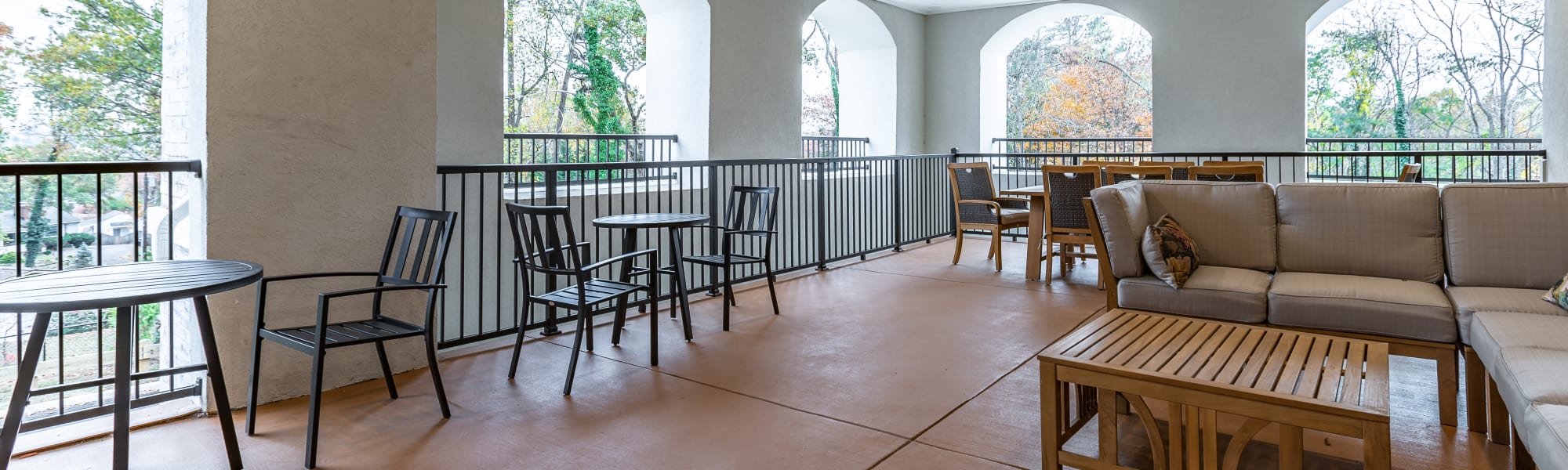 paved patio outside of a unit with chairs at The Blake at Charlottesville in Charlottesville, Virginia