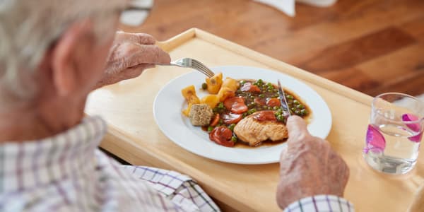 Resident enjoying a simple and delicious meal at Geneva Lake Manor in Lake Geneva, Wisconsin